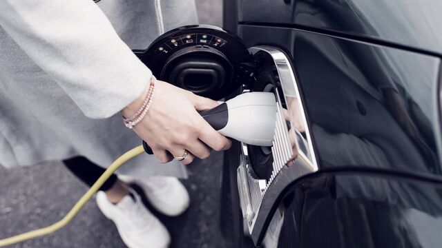 Woman charging electric car - Small